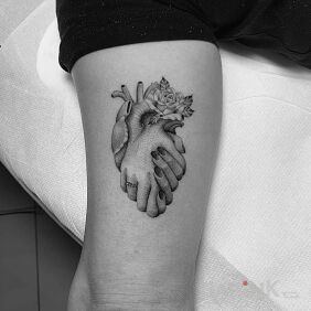 Tattoo Take the heart by the hand On the arm motif: black and gray style: realistic