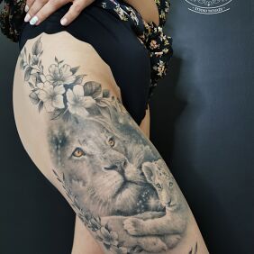 Tattoo Lions - lioness and cub, flowers, star constellations on the thigh motif: black and gray style: realistic