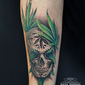 Tattoo Santa Muerte and marijuana leaves on the forearm motif: skulls style: realistic