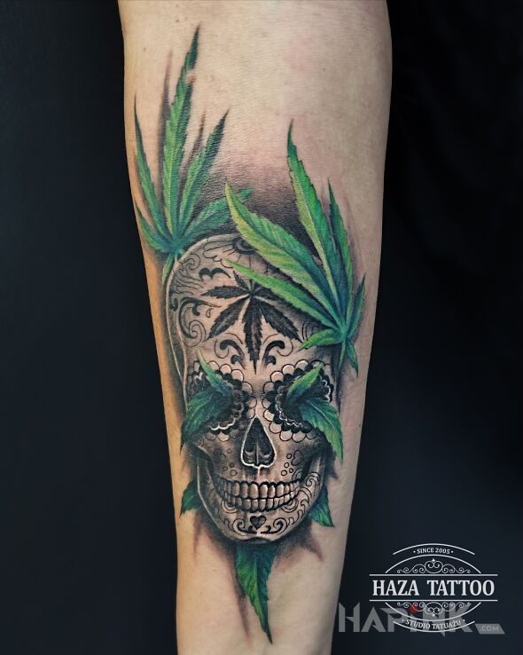 Tattoo Santa Muerte and marijuana leaves in floral motif and realistic style On the arm