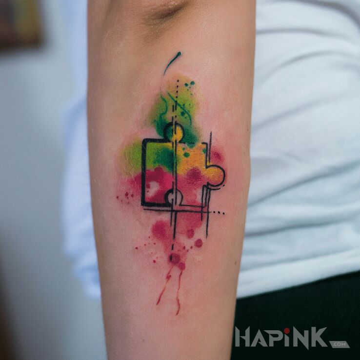Tattoo Puzzle in colorful motif and Watercolor style On the arm