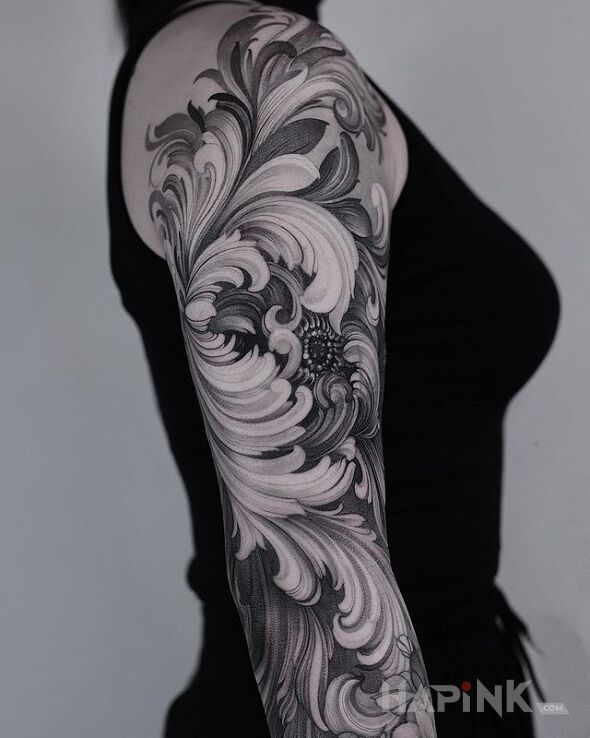 Tattoo Cudaczny kwiat in black and gray motif and graphic / illustrative style on the upper arm