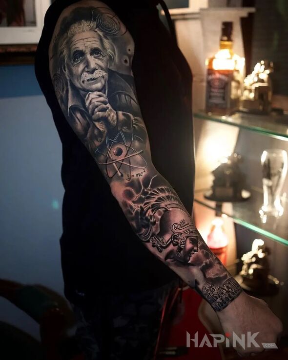 Tattoo Albert Einstein ze złożonymi rączkami in faces motif and realistic style on the upper arm