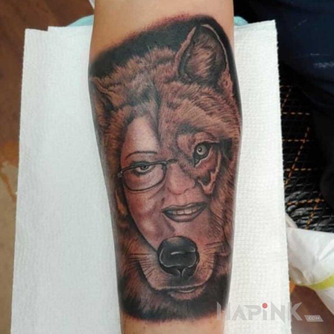 Tattoo Kobieta wilk 😆 in black and gray motif and realistic style on the forearm