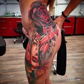 Tattoo Girl in red on the leg motif: flowers