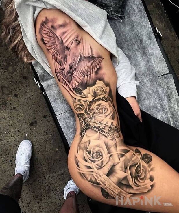 Tattoo Tatuaż związany z wiarą in flowers motif and realistic style on the thigh