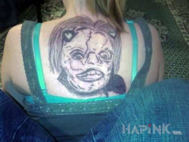 Tattoo Potworek in faces motif on the back