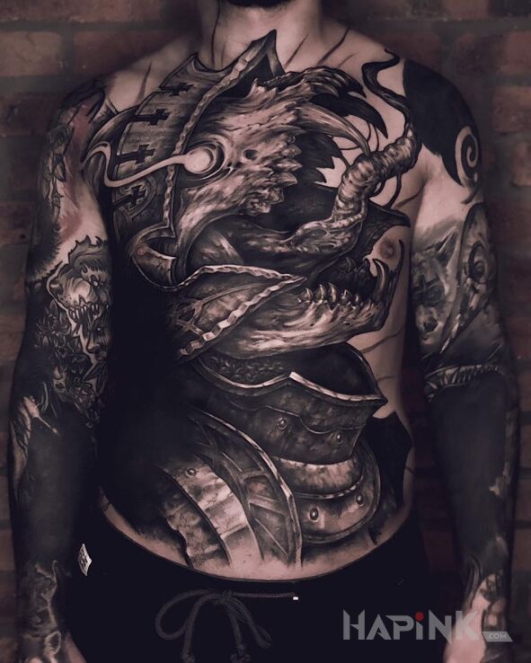 Tattoo Ooo kyrie eleison in demons motif and blackwork / blackout style on the stomach