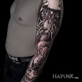 Tattoo Demonic seed on the upper arm motif: faces style: graphic / illustrative