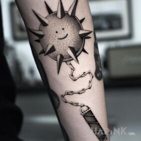 Tattoo Spiky ball on the forearm motif: black and gray style: realistic