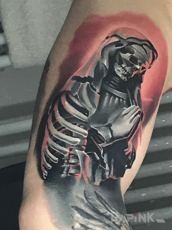 Tattoo Zakonnica in black and gray motif and graphic / illustrative style on the bicep