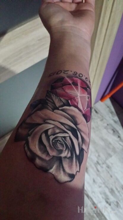Tattoo Mój in flowers motif on the forearm