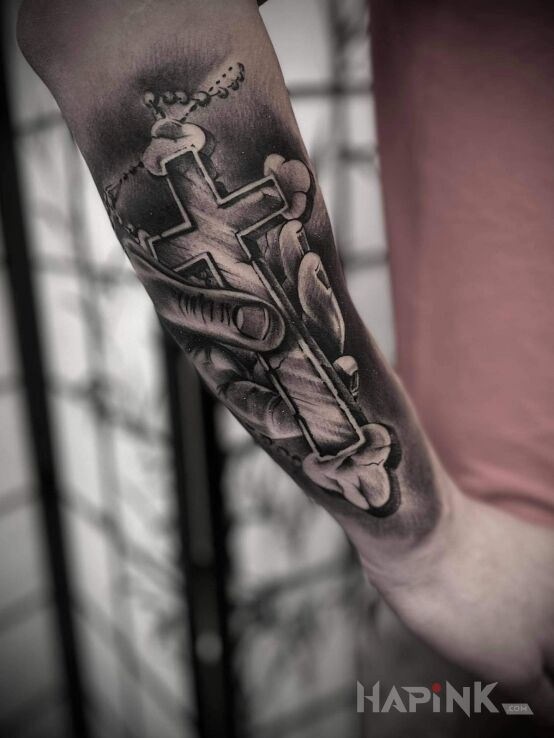 Tattoo Krzyż in objects motif and realistic style on the forearm