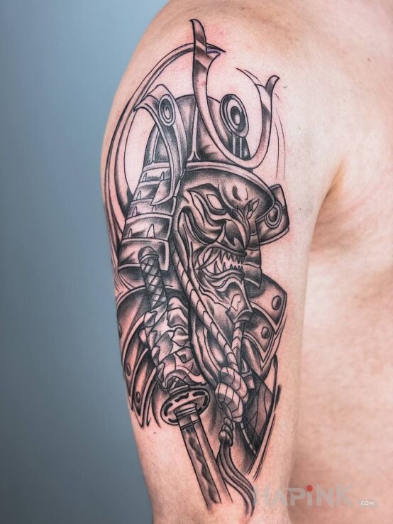 Tattoo Samurai in black and gray motif and graphic / illustrative style on the upper arm