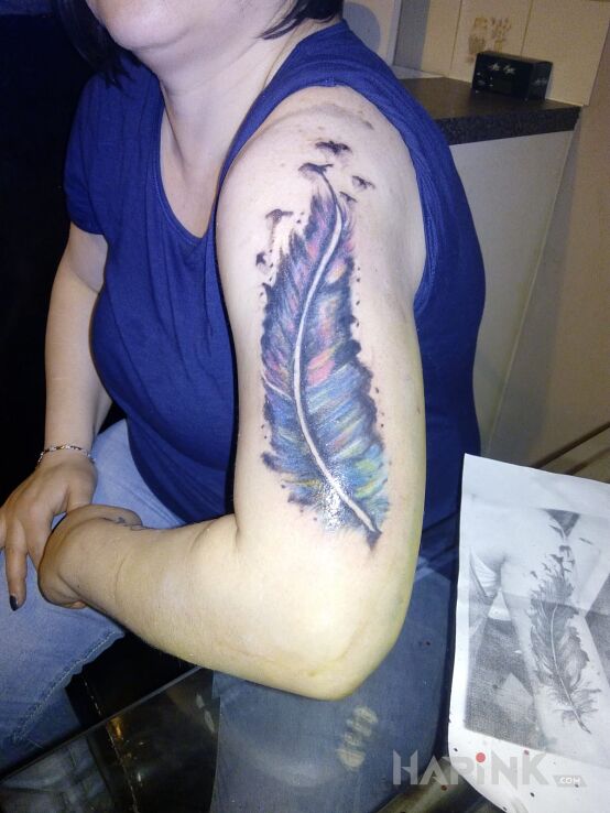 Tattoo Super in anatomical motif on the upper arm