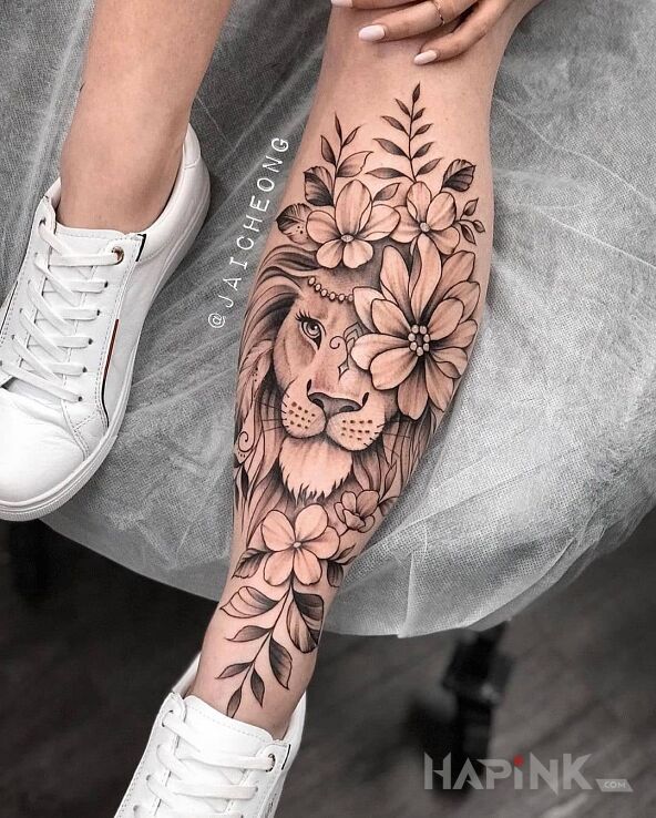 Tattoo Urodziwe lwisko in flowers motif and graphic / illustrative style on the leg