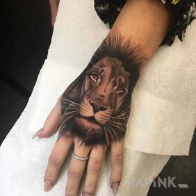 Tattoo Lion as in the palm of your hand on the hand motif: animals style: realistic