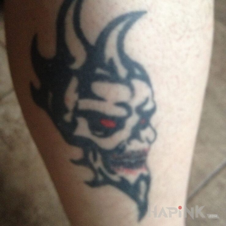 Tattoo Dusza in demons motif on the leg
