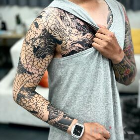 Tattoo Faded color dragon on the upper arm motif: dragons style: japanese / irezumi