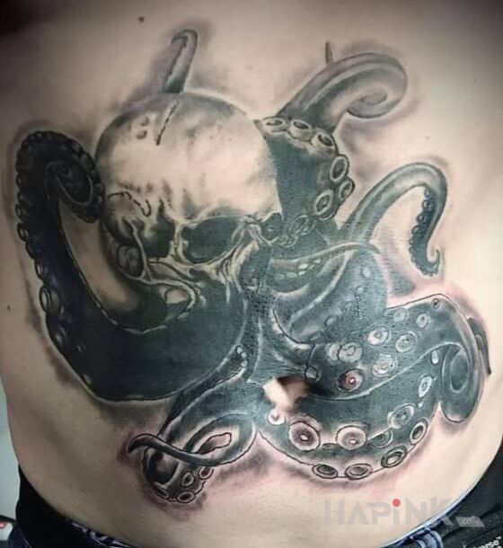 Tattoo Czaszko-ośmironica in skulls motif and blackwork / blackout style on the stomach