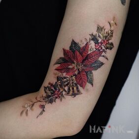 Tattoo Christmas babe on the upper arm motif: objects style: realistic