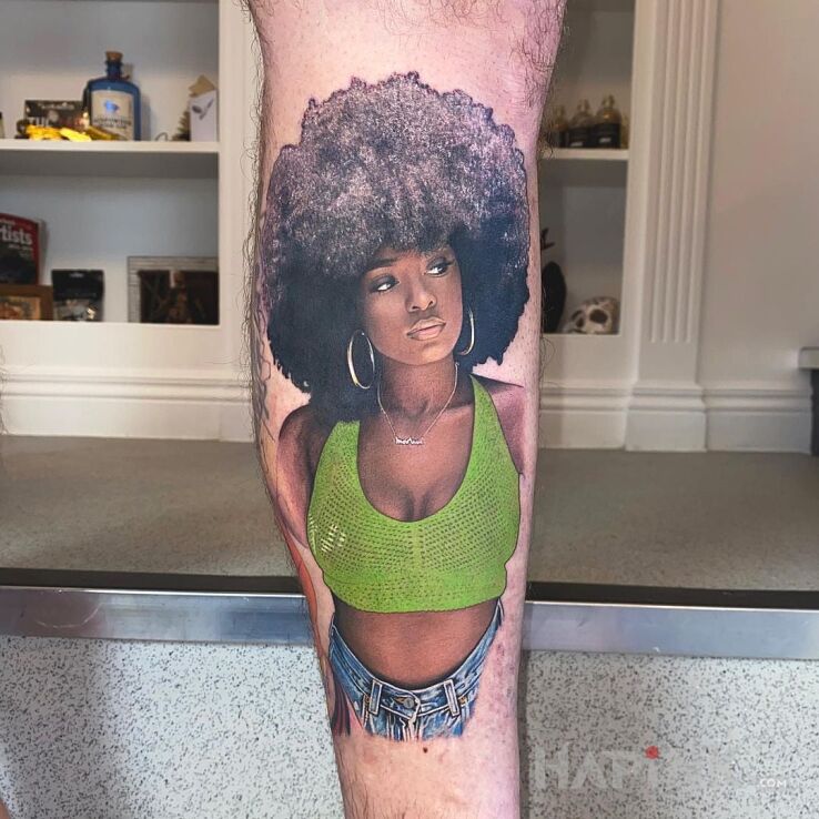 Tattoo Mega mega portret z afro in faces motif and realistic style on the calf