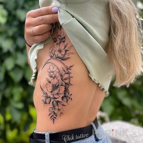 Tattoo Moon hidden among flowers on the ribs motif: floral style: graphic / illustrative