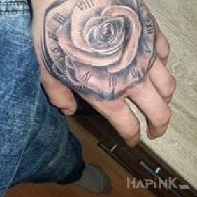 Tattoo Rose with clock on the hand motif: flowers