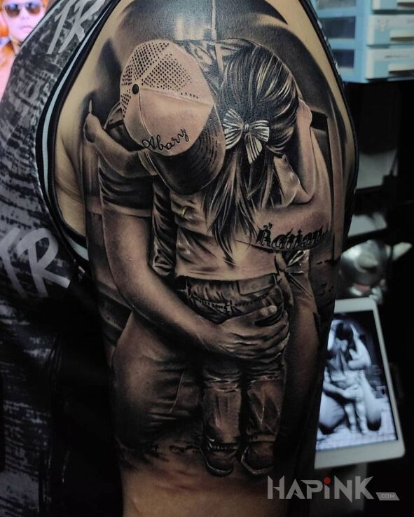 Tattoo Przytulas in black and gray motif and realistic style on the upper arm