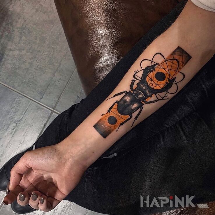 Tattoo Lucanus cervus in colorful motif and realistic style on the forearm
