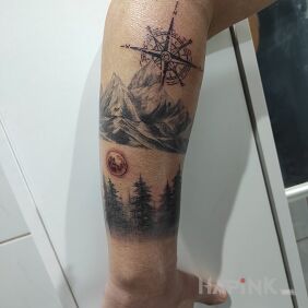 Tattoo Forest, mountains, compass rose On the arm motif: black and gray style: graphic / illustrative