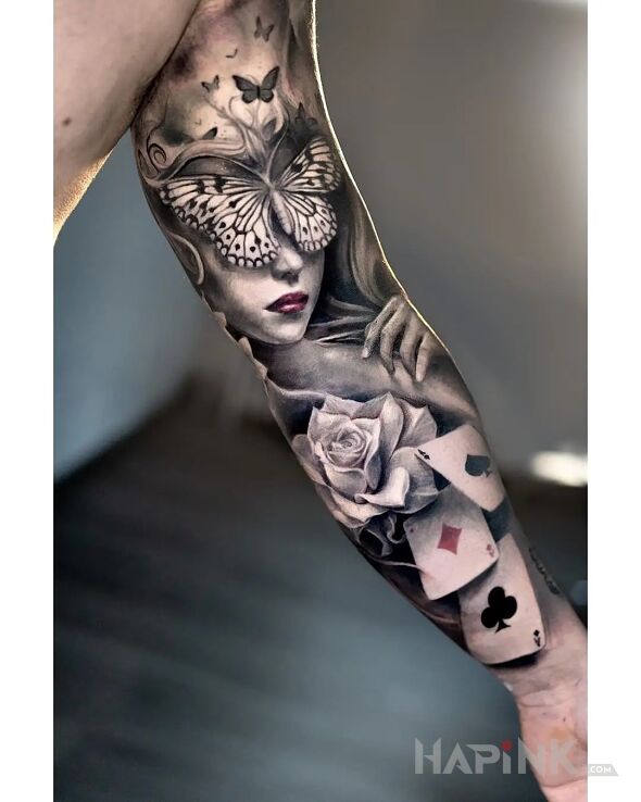 Tattoo Zaslepiona przez motyle in black and gray motif and realistic style On the arm