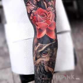 Tattoo Owl under a rose on the bicep motif: flowers style: realistic