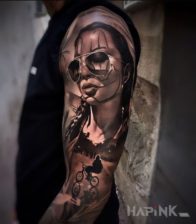 Tattoo Rowerowa dziewczyna in black and gray motif and realistic style on the upper arm