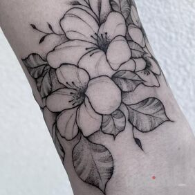 Tattoo Flowers on the forearm motif: black and gray style: graphic / illustrative