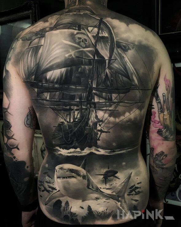 Tattoo Piracki okret in black and gray motif and realistic style on the shoulder blades
