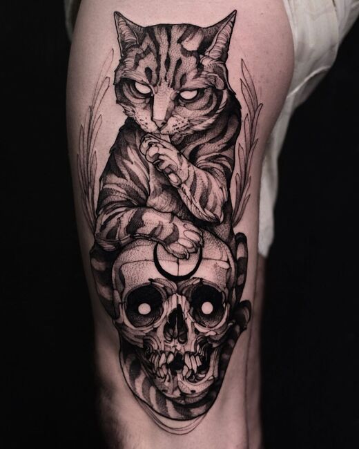 czarno-szary tatuaż kota i czaszki na nodze