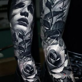 Tattoo A woman's face among roses on the bicep motif: sleeves style: realistic