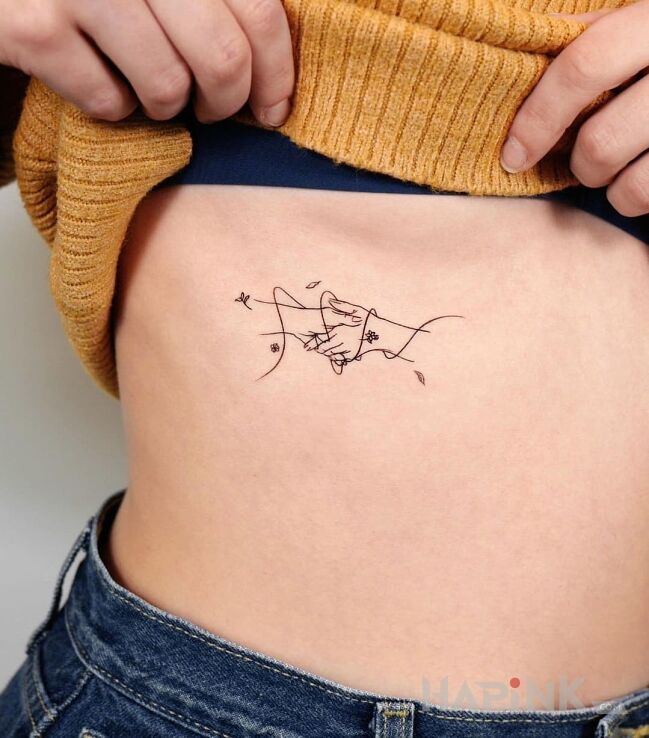 Tattoo Raczka do raczki in other motif and minimalistic style on the ribs