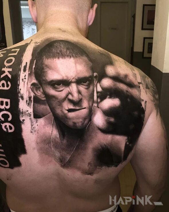 Tattoo Nienawiść in faces motif and realistic style on the back