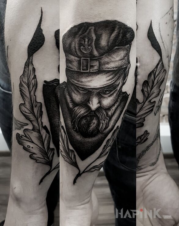 Tattoo Hubal in patriotic motif on the forearm
