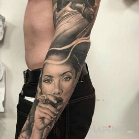 Tattoo Cigar girl on the upper arm motif: sleeves style: realistic