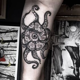 Tattoo Octopus On the arm motif: black and gray style: graphic / illustrative