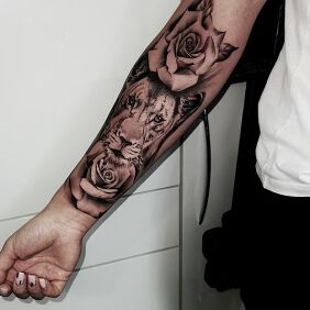 Tattoo Lioness On the arm motif: black and gray style: realistic