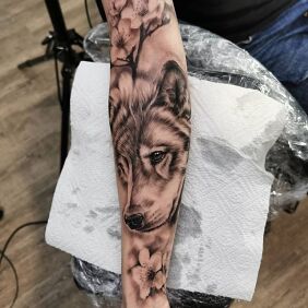 Tattoo She-wolf On the arm motif: black and gray style: realistic