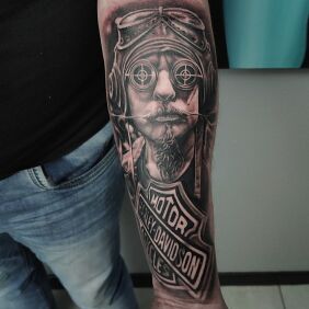 Tattoo Harley-Davidson On the arm motif: motorization style: realistic