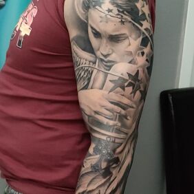 Tattoo Angel and stars on the upper arm motif: black and gray style: realistic