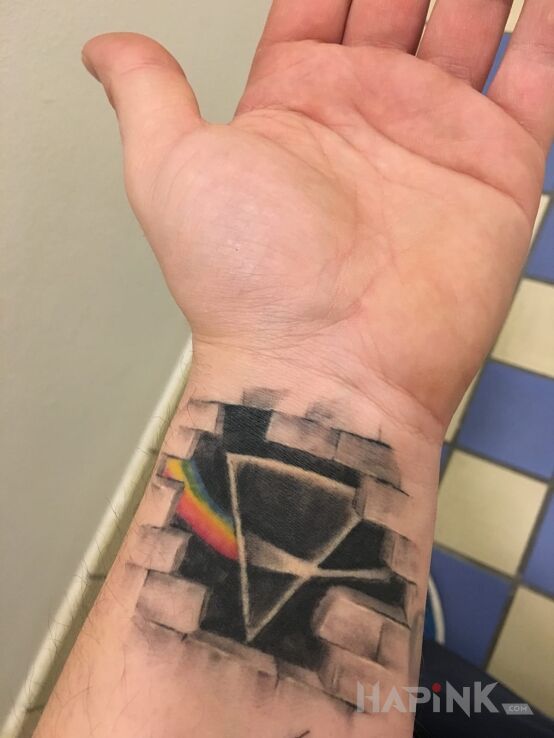 Tattoo Pink Floyd in other motif on the wrist