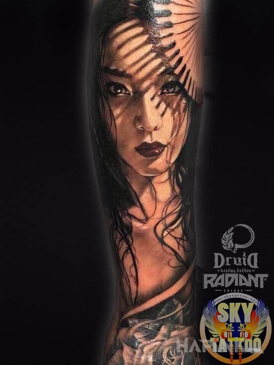 Tattoo Gra cieni in faces motif and realistic style On the arm