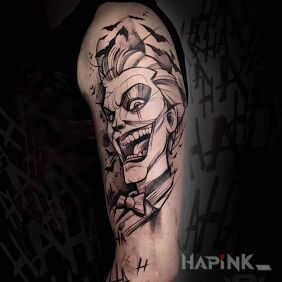 Tattoo Crazy Joker on the upper arm motif: black and gray style: sketch